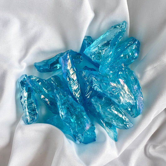Blue Angel Aura Quartz, created by bonding quartz with precious metals, enhances communication and spiritual connection.