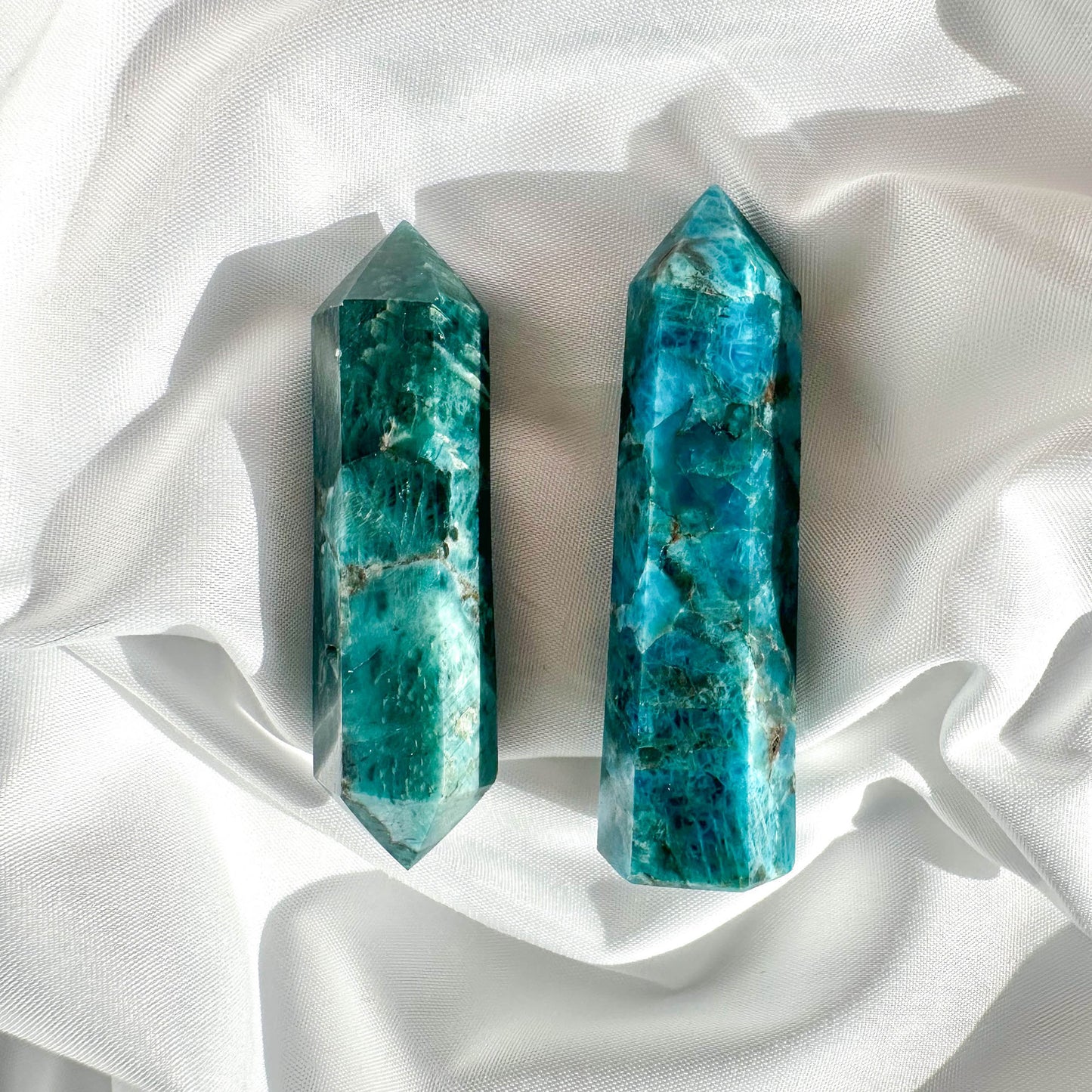 BlueApatite-Points - Best Healing Crystal for Her - Blue Apatite is known for its inspirational properties, aiding in personal growth and clarity of mind. It enhances communication and self-expression. In point or double terminated form, it effectively channels and directs energy, making it ideal for focus and clarity.