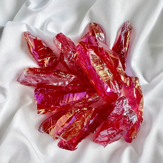 Red Angel Aura Quartz enhances vitality and passion. Its raw form retains a high vibrational energy, perfect for grounding and strength.