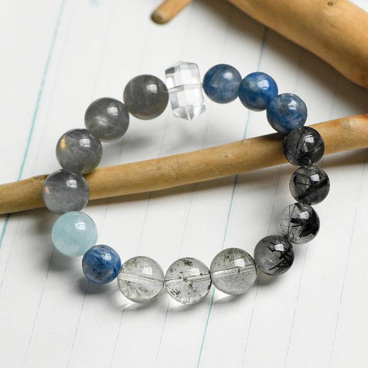 This celestial bracelet features a thoughtfully curated blend of Green Phantom Quartz, Aquamarine, Clear Quartz, Rutilated Quartz, and Moonstone, each chosen to reflect the colours, movement, and emotion of the masterpiece.