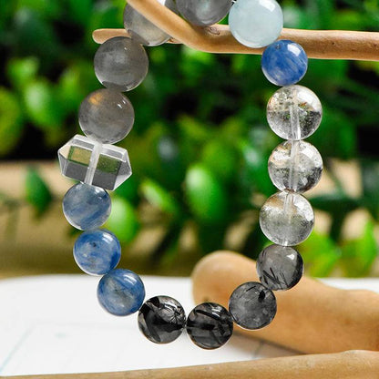 Green Phantom Quartz symbolizes growth rising through the darkness, Aquamarine brings the calm of a night sky in motion, Clear Quartz adds radiant clarity, Rutilated Quartz mirrors the golden streaks of starlight, and Moonstone embodies lunar glow and intuitive flow.